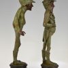 A pair of figural candlesticks jockey and gentleman