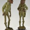 A pair of figural candlesticks jockey and gentleman