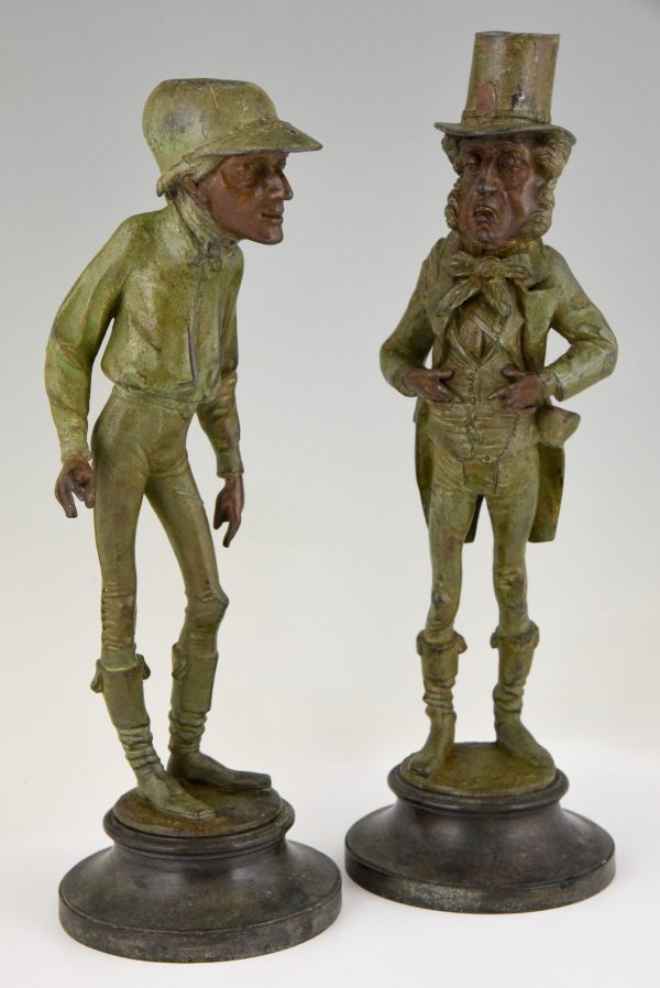 A pair of figural candlesticks jockey and gentleman