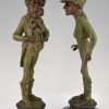 A pair of figural candlesticks jockey and gentleman