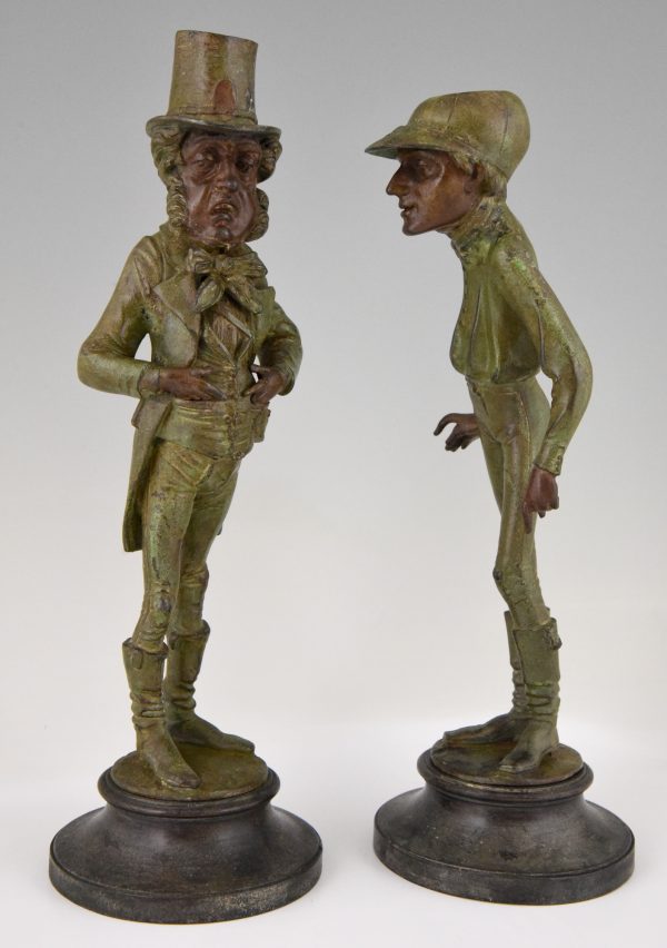 A pair of figural candlesticks jockey and gentleman