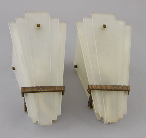 A pair of Art Deco glass and bronze wall lights or sconces