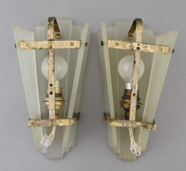 A pair of Art Deco glass and bronze wall lights or sconces