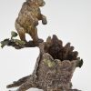 Antique Vienna bronze bear on a tree trunk