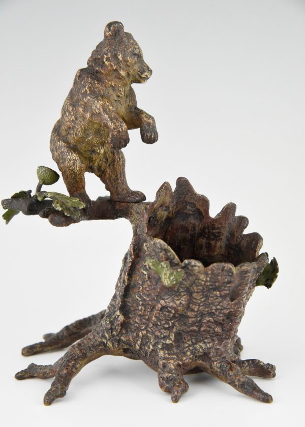 Antique Vienna bronze bear on a tree trunk