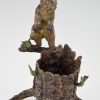 Antique Vienna bronze bear on a tree trunk