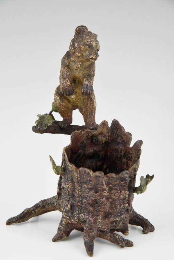 Antique Vienna bronze bear on a tree trunk