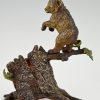 Antique Vienna bronze bear on a tree trunk