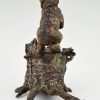 Antique Vienna bronze bear on a tree trunk