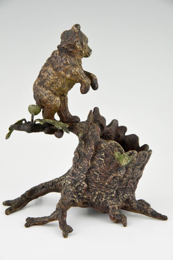 Antique Vienna bronze bear on a tree trunk