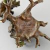 Antique Vienna bronze bear on a tree trunk