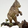 Antique Vienna bronze bear on a tree trunk