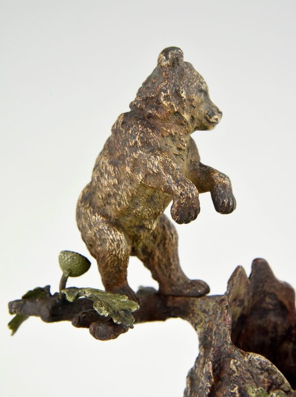 Antique Vienna bronze bear on a tree trunk