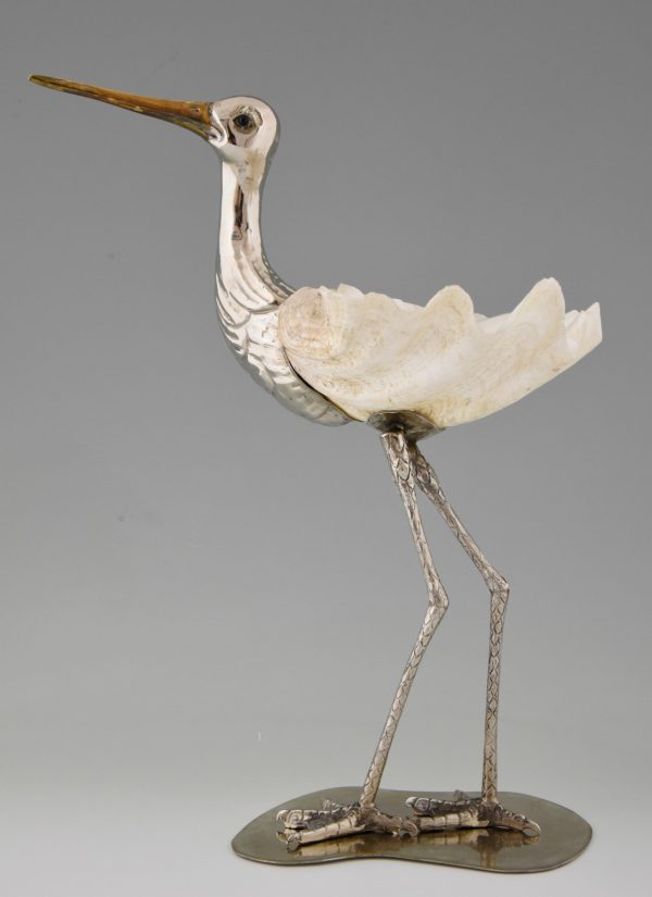 Modern sculpture of a bird silvered metal and seashell