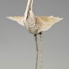 Modern sculpture of a bird silvered metal and seashell