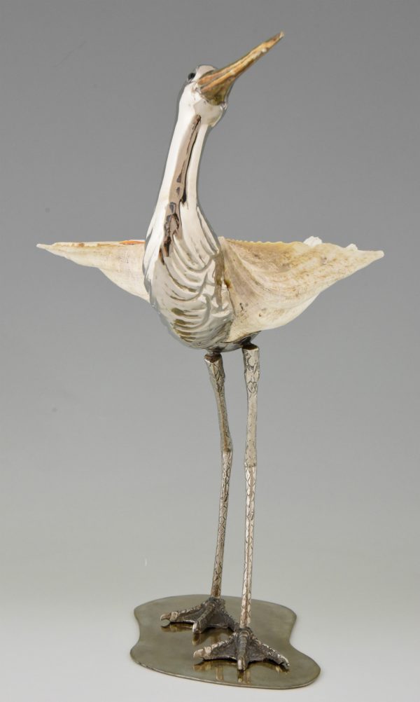 Modern sculpture of a bird silvered metal and seashell