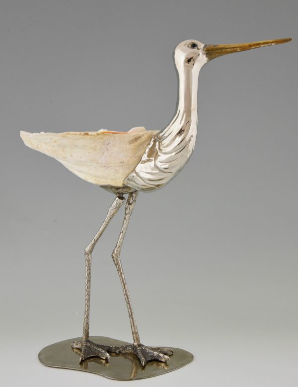 Modern sculpture of a bird silvered metal and seashell