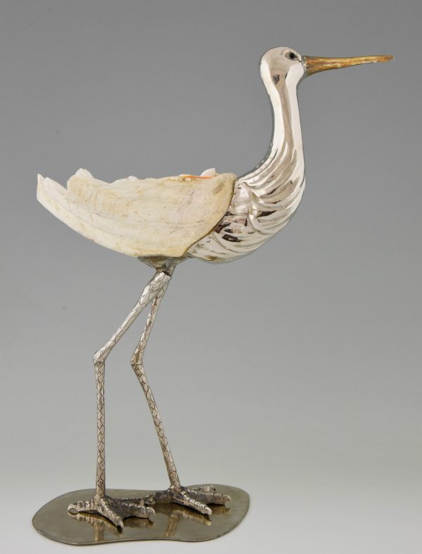 Modern sculpture of a bird silvered metal and seashell