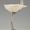 Modern sculpture of a bird silvered metal and seashell