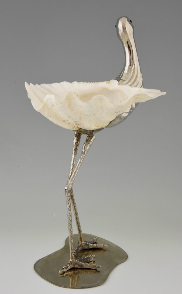 Modern sculpture of a bird silvered metal and seashell