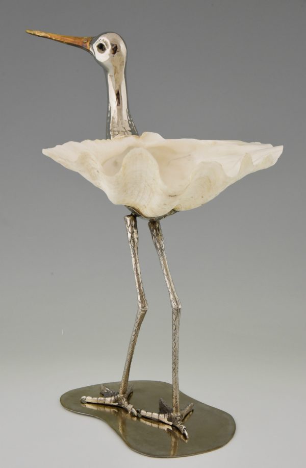 Modern sculpture of a bird silvered metal and seashell