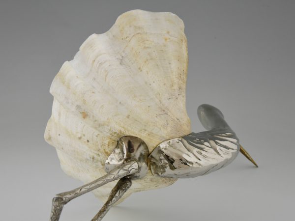 Modern sculpture of a bird silvered metal and seashell