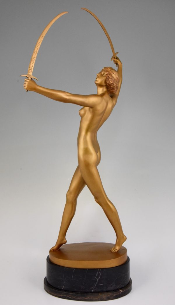 Art Deco gilt bronze sculpture of a nude with two swords.