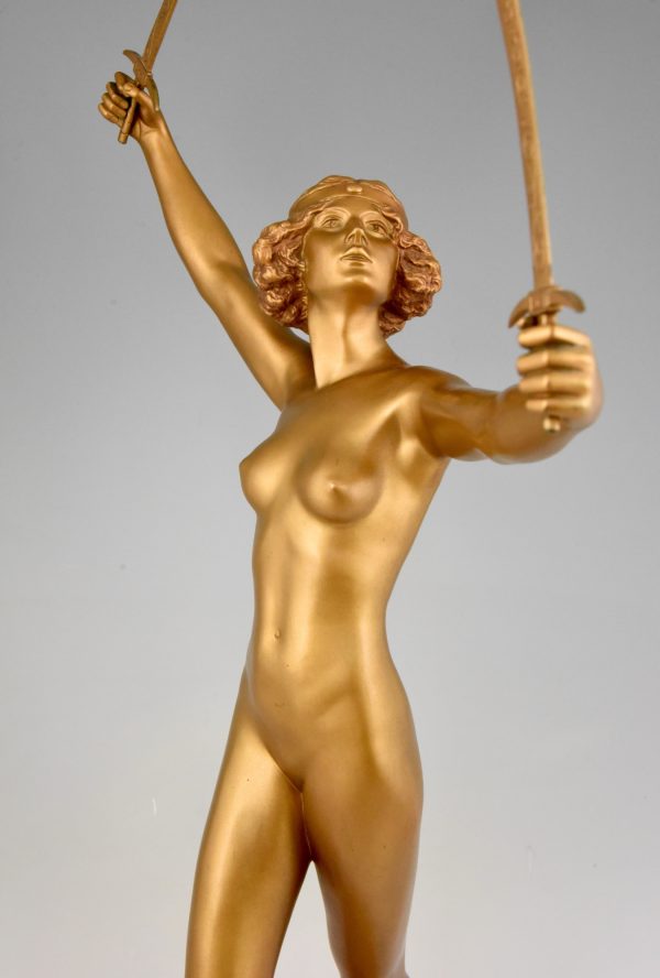 Art Deco gilt bronze sculpture of a nude with two swords.