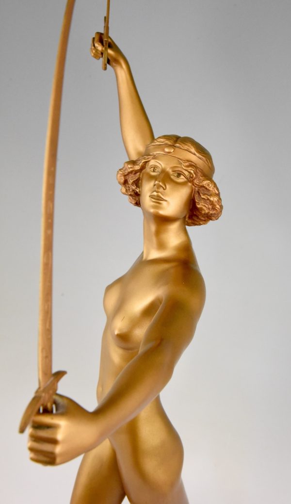 Art Deco gilt bronze sculpture of a nude with two swords.