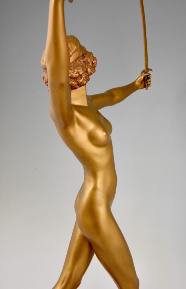 Art Deco gilt bronze sculpture of a nude with two swords.