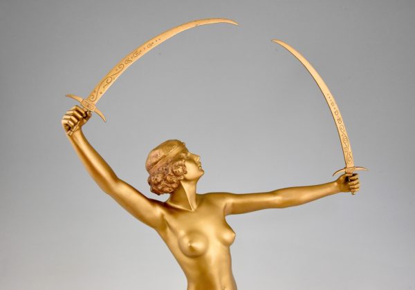 Art Deco gilt bronze sculpture of a nude with two swords.