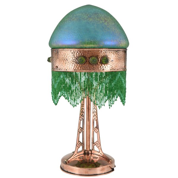 Art Nouveau copper table lamp with Loetz glass shade.