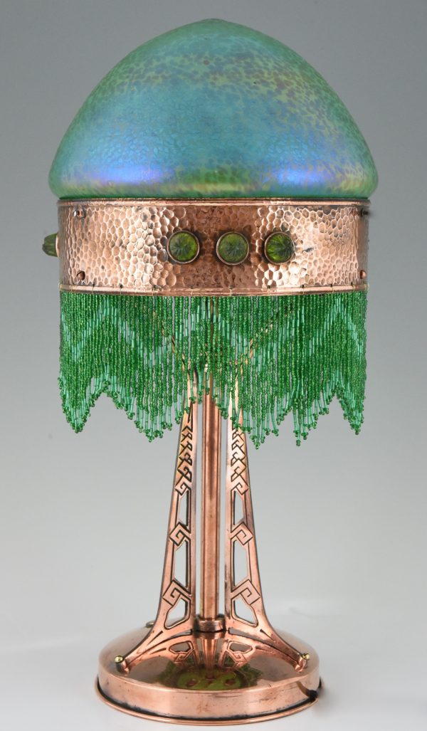 Art Nouveau copper table lamp with Loetz glass shade.