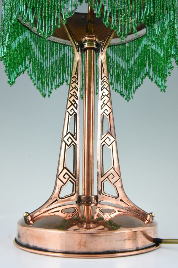Art Nouveau copper table lamp with Loetz glass shade.