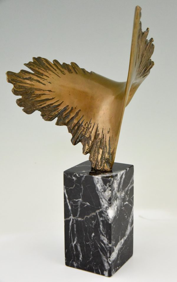 Bronze sculpture of a stylized eagle