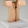 Bronze abstract sculpture on a white marble base