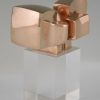 Bronze abstract sculpture on plexiglass base.