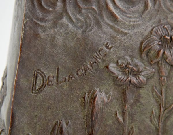 Art Nouveau bronze vase with woman’s face and flowers