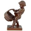 Antique bronze of a boy with basket