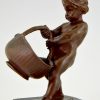 Antique bronze of a boy with basket