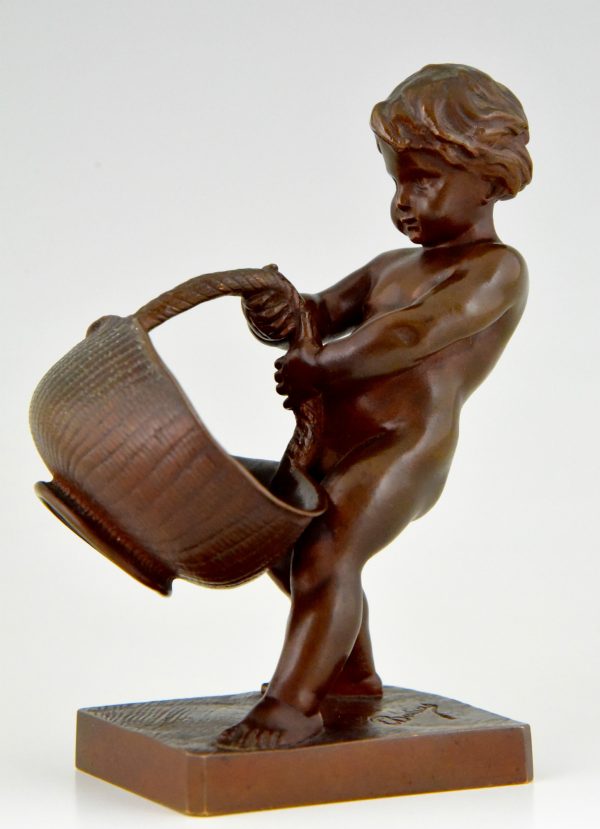 Antique bronze of a boy with basket