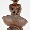 Antique bronze of a boy with basket