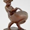 Antique bronze of a boy with basket