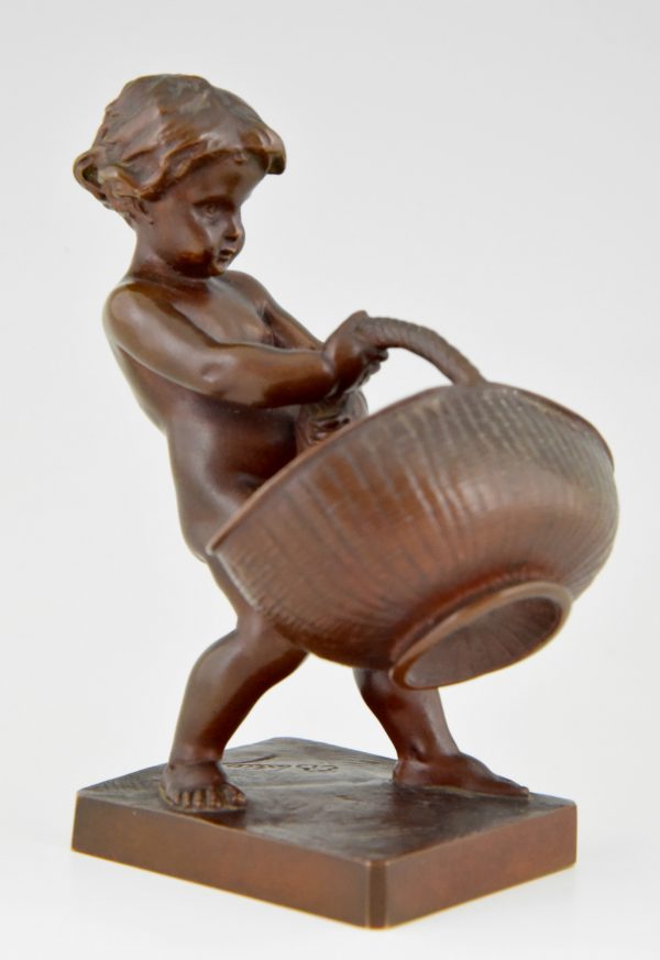 Antique bronze of a boy with basket