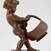 Antique bronze of a boy with basket