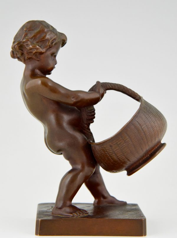 Antique bronze of a boy with basket