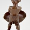 Antique bronze of a boy with basket