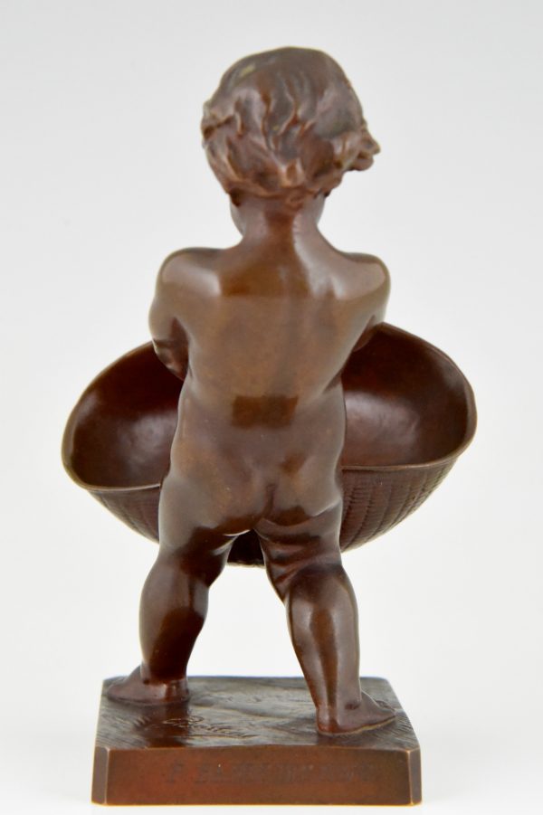 Antique bronze of a boy with basket