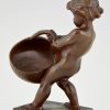 Antique bronze of a boy with basket