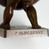 Antique bronze of a boy with basket